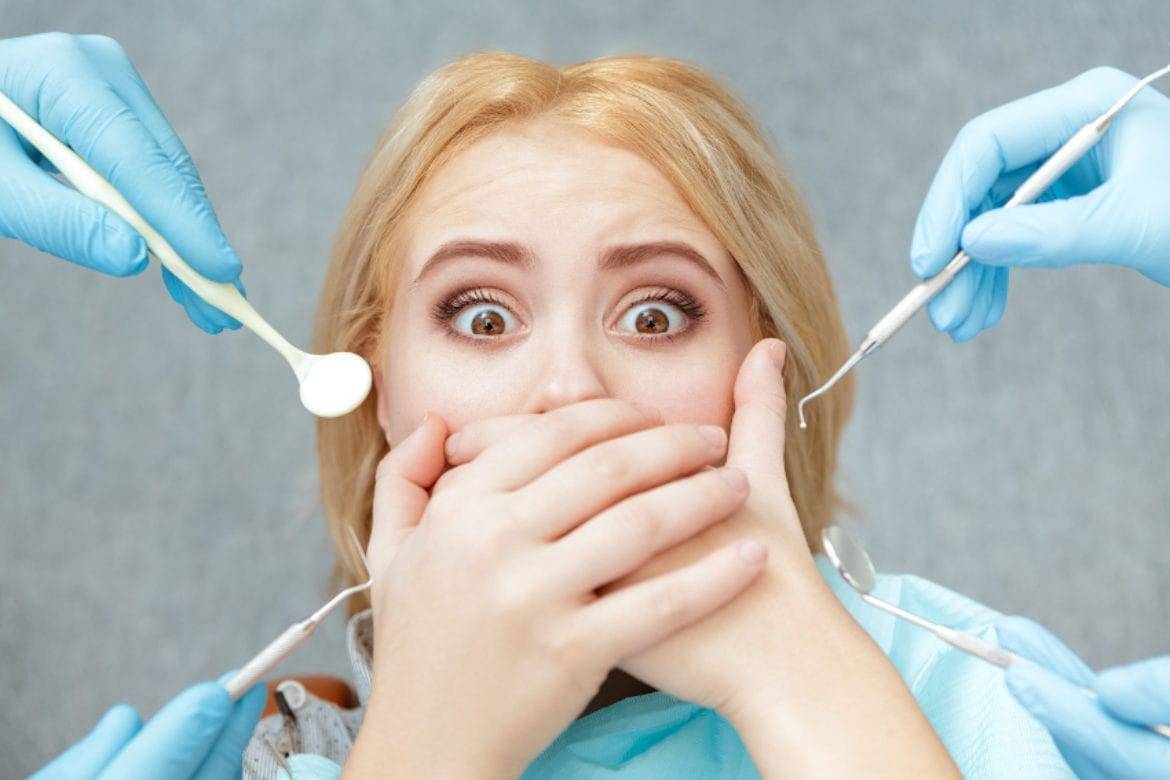Girl With Dental Anxiety Covering Mouth