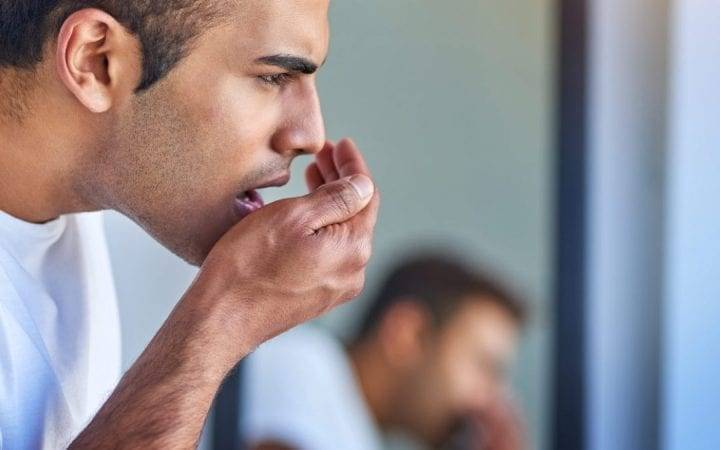 Man Smelling His Own Breath